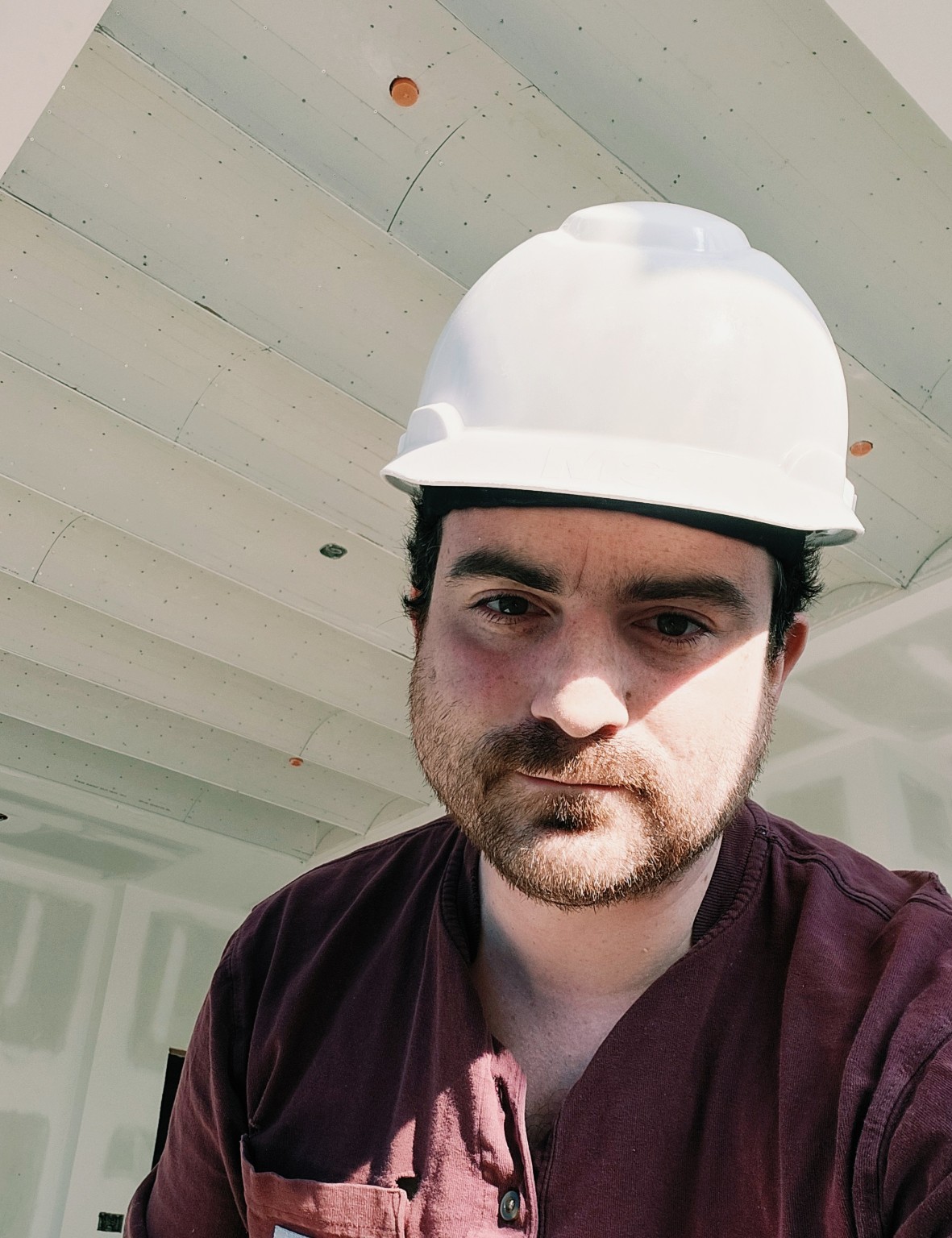 James Ferrentino wearing a hard hat on a construction site.